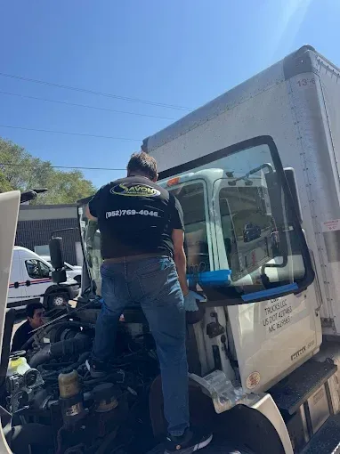 A Savon technician working on a box truck